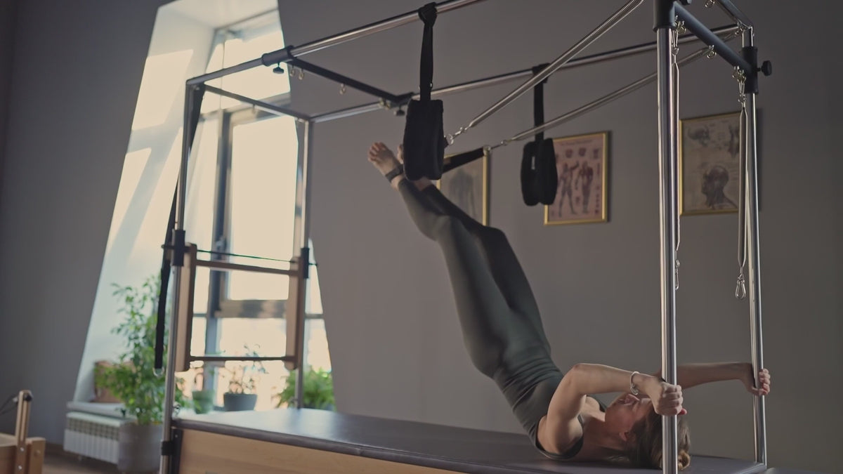 Load video: A Pilates session in a studio setting