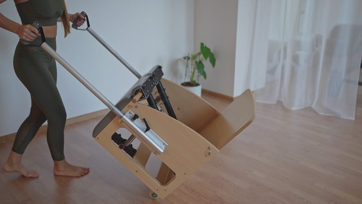 Load video: A Pilates session in a studio setting