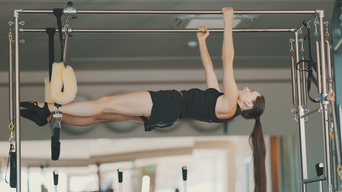 Load video: Advanced suspension work on a Cadillac trapeze table in a studio setting